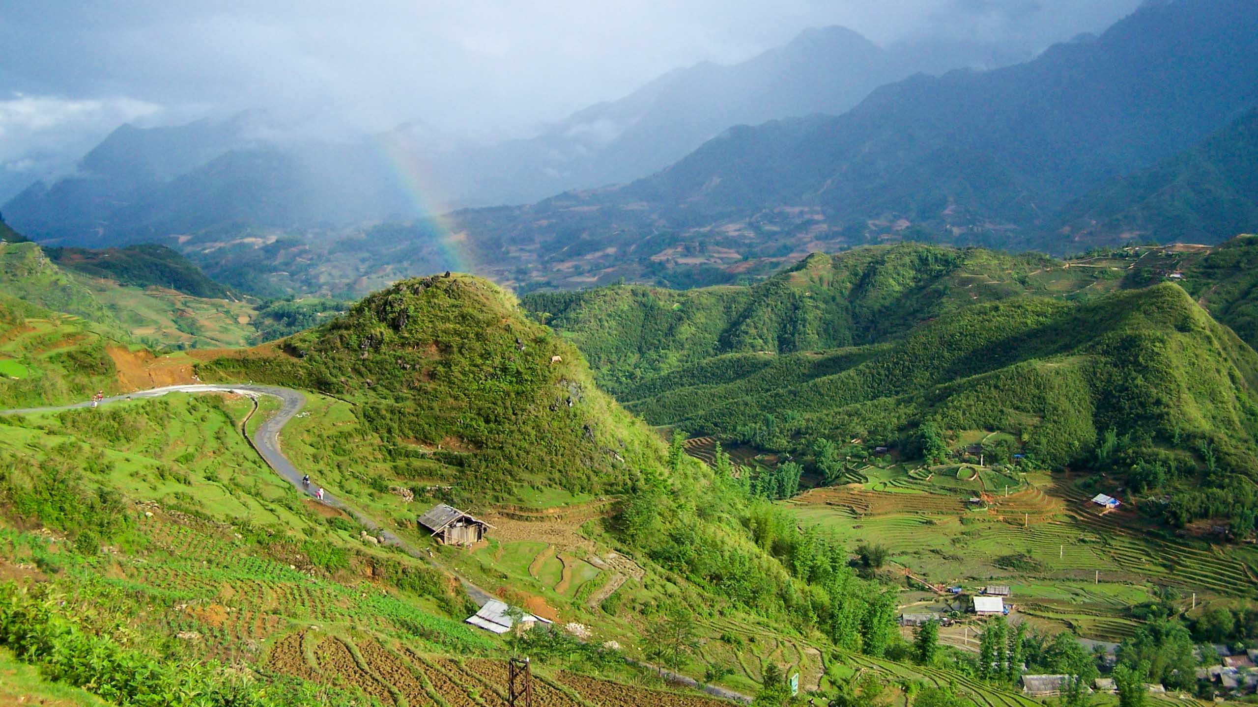 Rainbow over green Vietnam valley