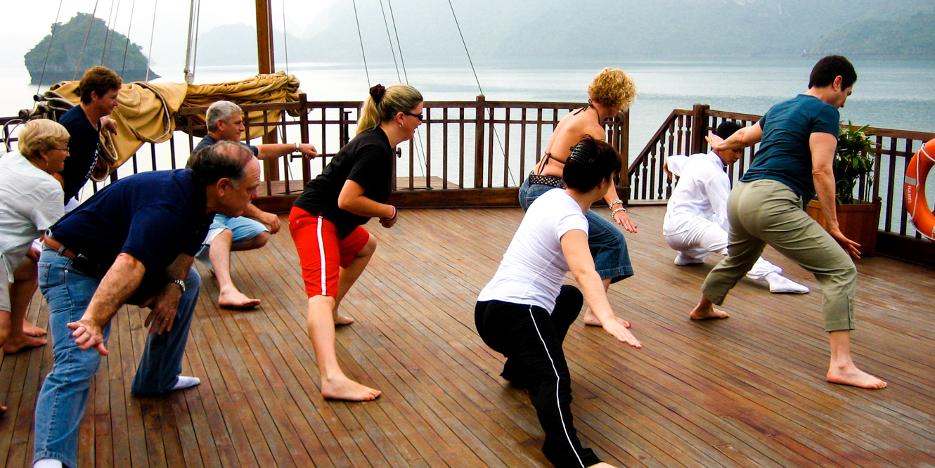 Travel group does yoga on Vietnam boat