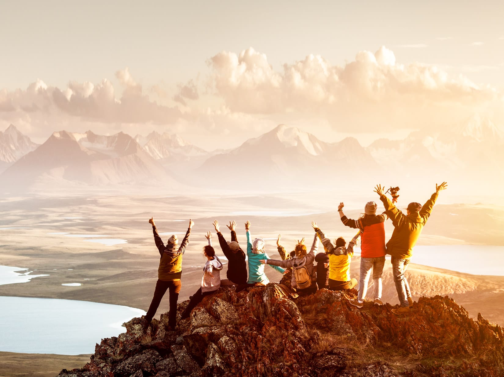 Travel group cheers from mountain top