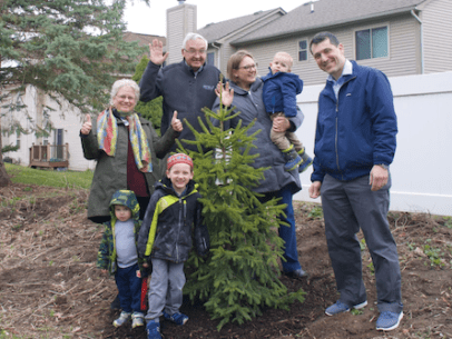 A family standing with a tree