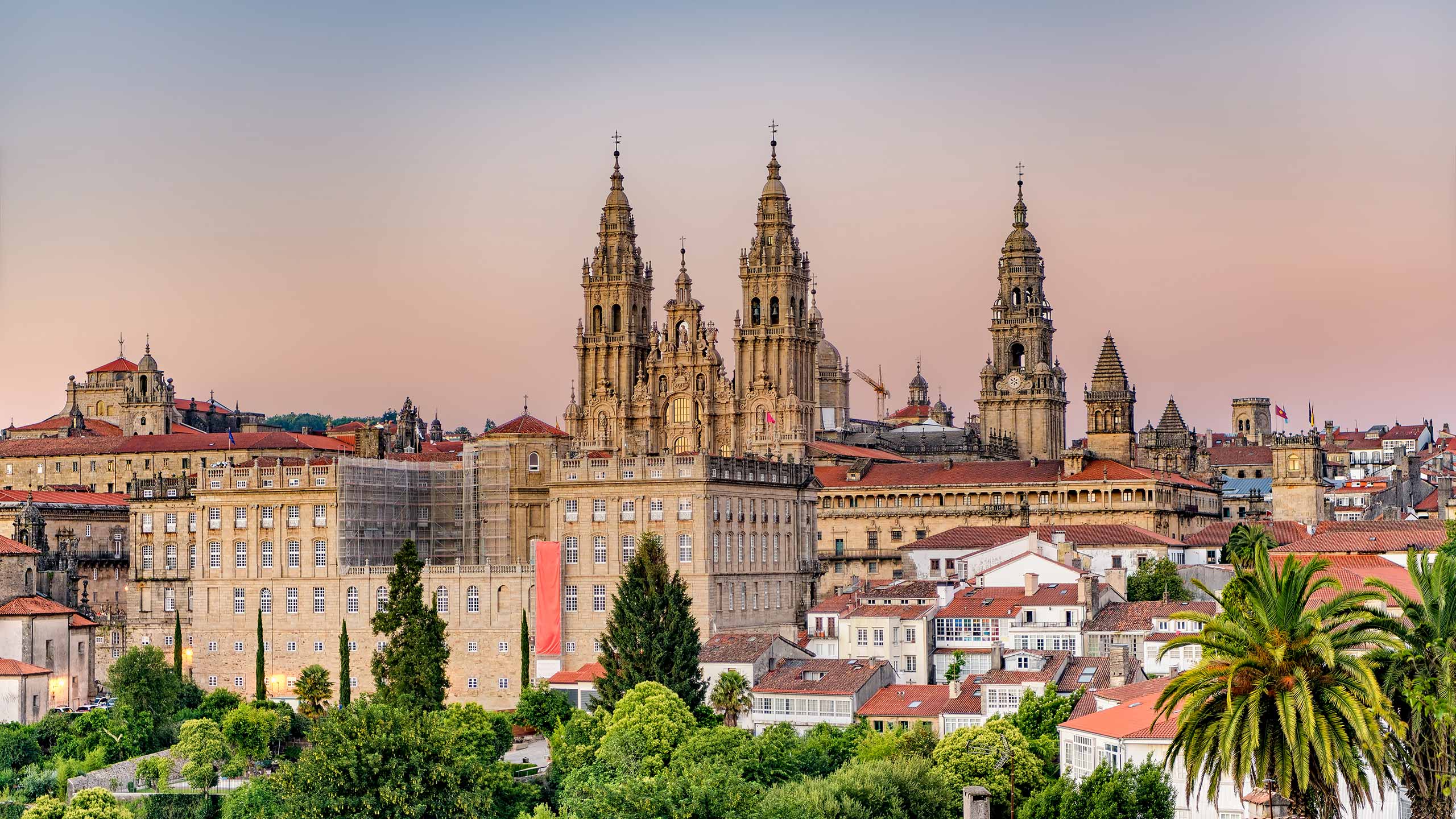 Hazy sunset on Santiago de Compostela cathedral and city view.