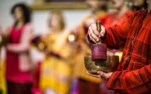 Man playing on a Tibetan singing bowl.