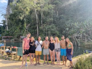 group of people by jungle pool