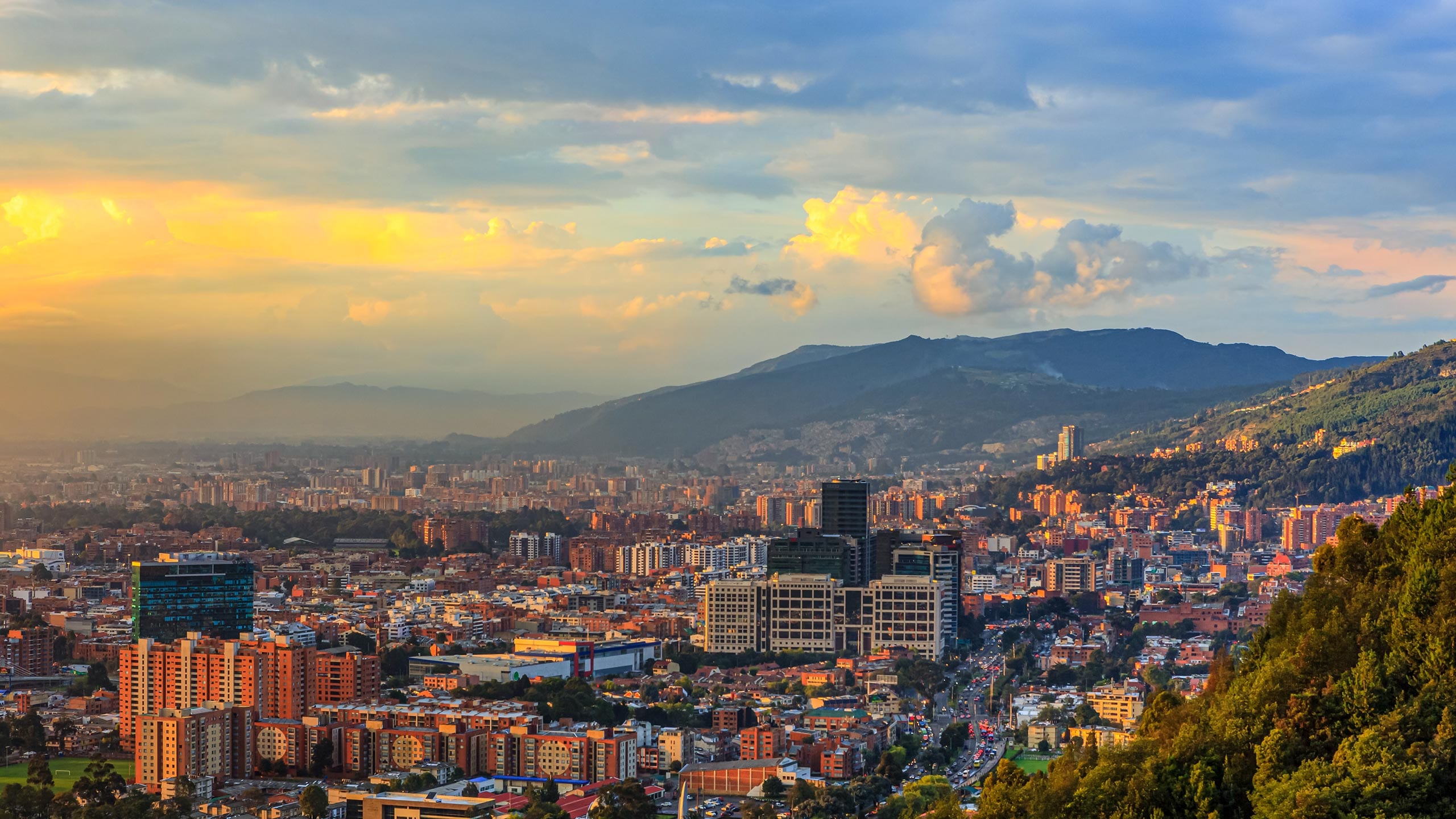 Bogota, Colombia - High Angle Panoramic View Of The Andean Capital City From The Heights Of La Calera On The Andes At Sunset Time