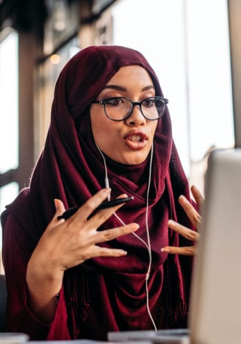 woman in hijab at computer