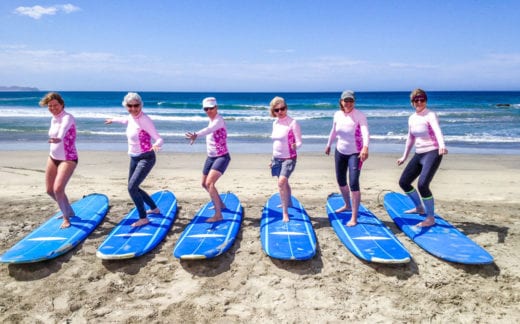 Ladies on surfboards on a beach in Baja, Mexico