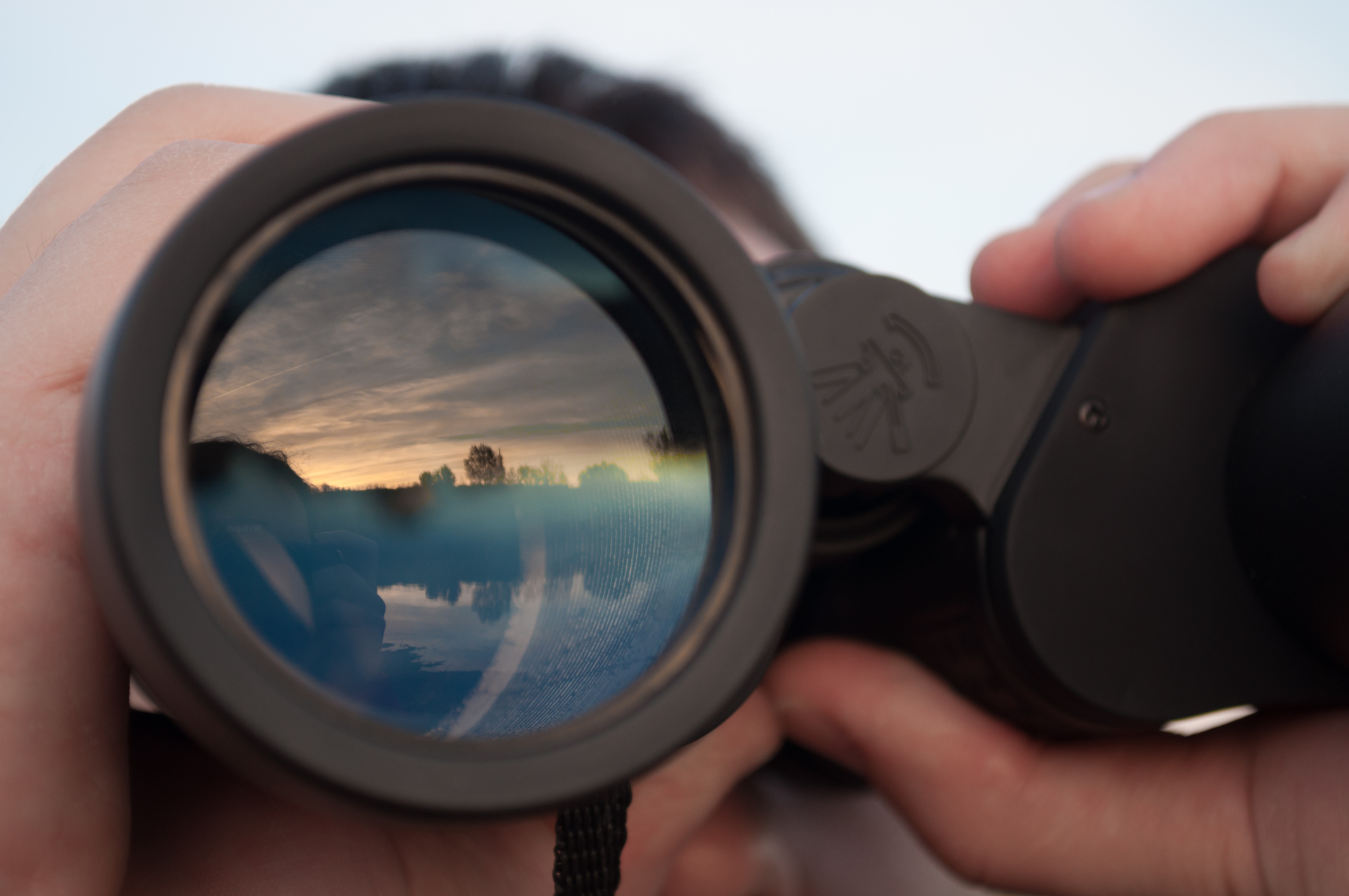 looking through binoculars