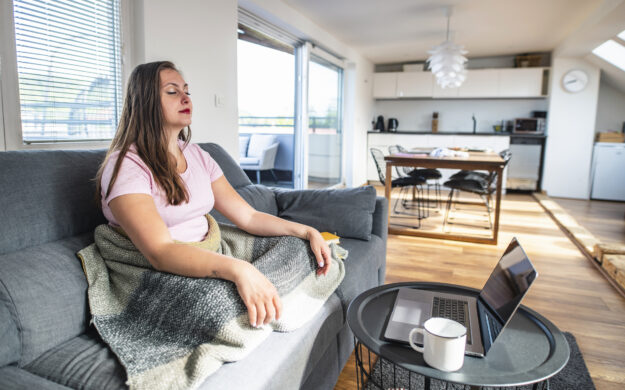 woman meditating in front of computer