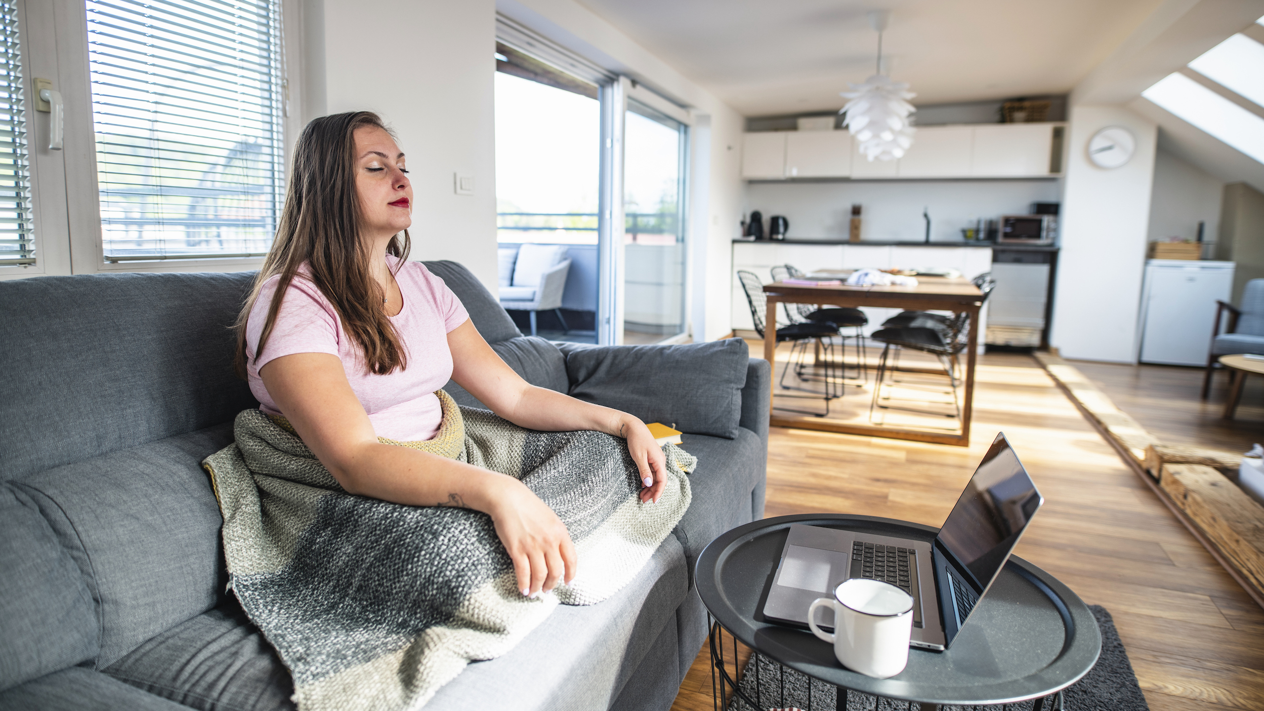 woman meditating in front of computer