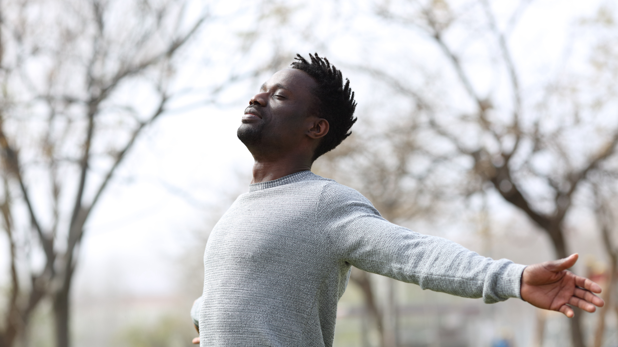 Man outdoors feeling fresh air on face