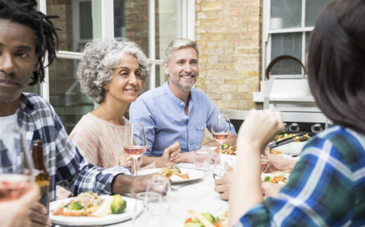 group of adults eating dinner outdoors