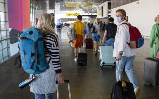 People walking in airport with luggage