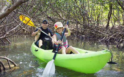 Father and daughter in double kayak