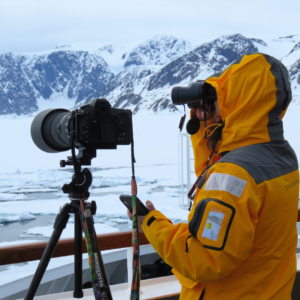 Explorer sets up camera on Arctic expedition ship