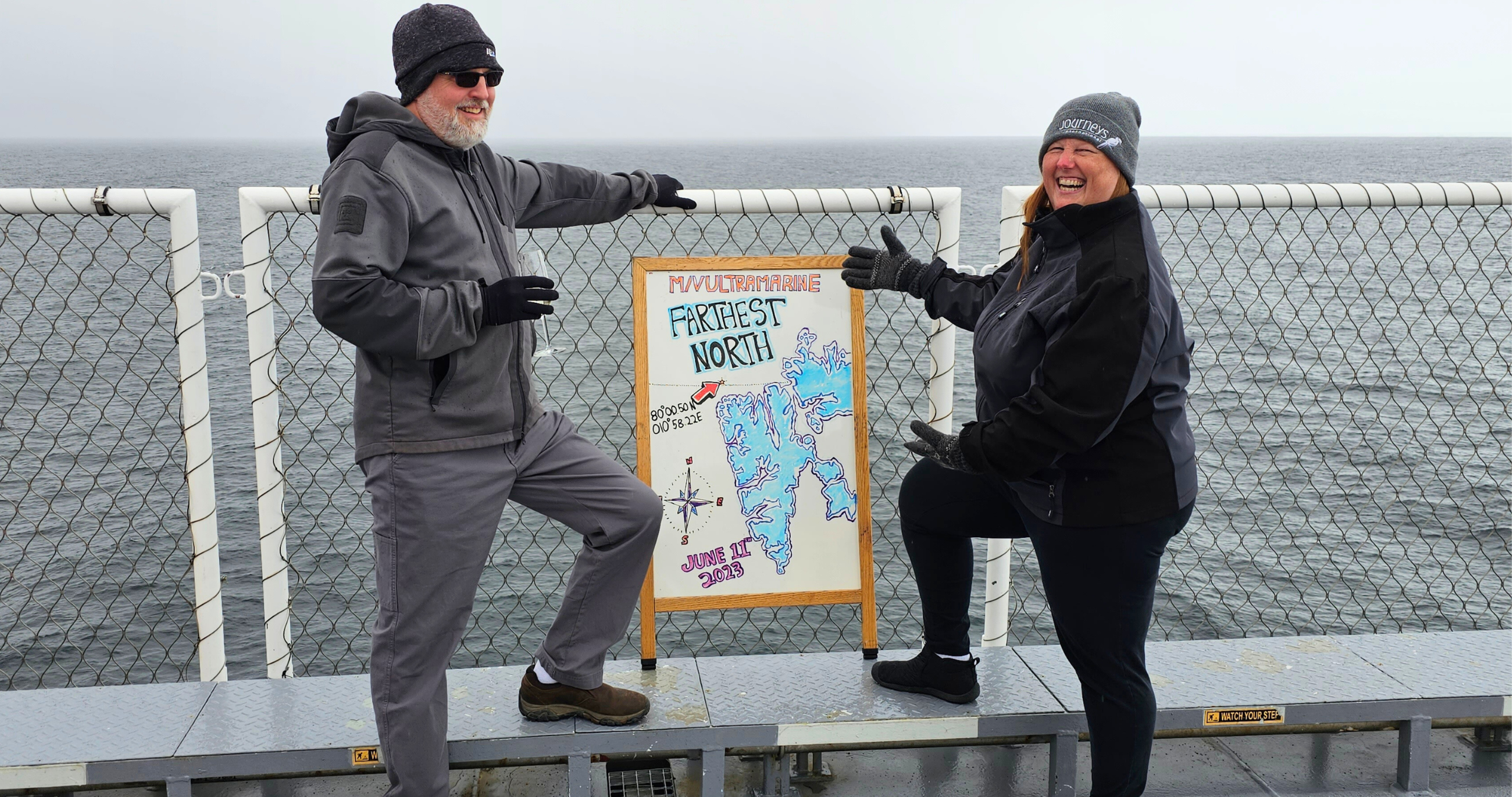 Journeys Adventure Specialist Lene stands with a map on an Arctic expedition.