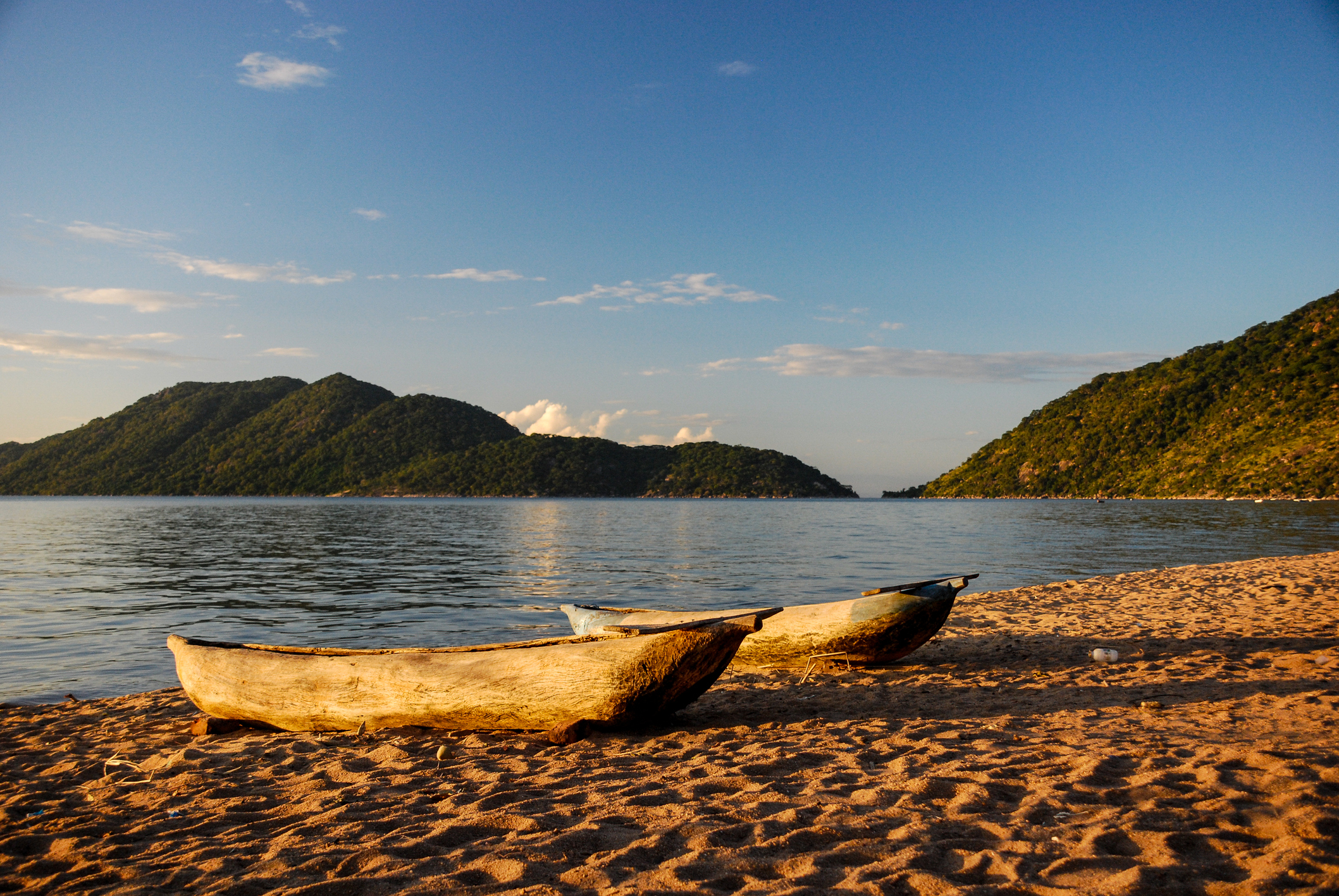 A pair of wooden canoes on the edge of the water of Lake Malawi, Malawi