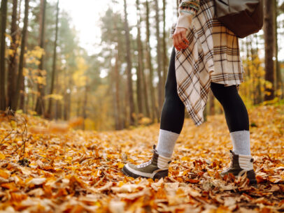 Hiker on forest trail in autumn