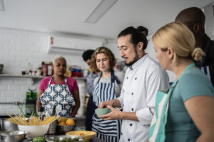 Chef giving instructions to students at cooking class