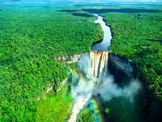 Aerial view of Kaieteur Falls with a rainbow in the Amazon rainforest, Guyana. One of the highest and most powerful waterfalls in the world, surrounded by lush tropical landscape